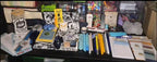 Assorted items on a desk including books, containers, and stationery.
